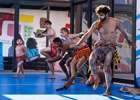 Aboriginal men dance on a stage