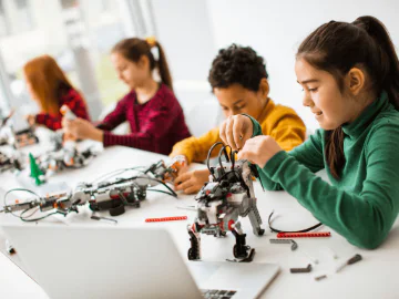 Young people making LEGO robotics in a class