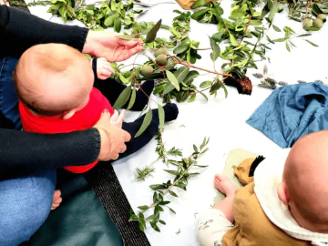 Babies using sensory items for playtime.