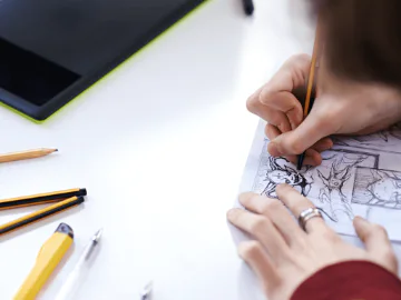 An artist making a comic strip
