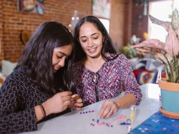 Mum and daughter making bead craft