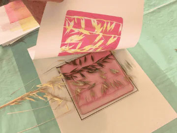 Reeds being imprinted onto a piece of paper