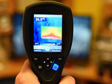 Close up of a thermal camera with temperature on it