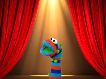 Red theatre curtains with a blue sock puppet in the centre