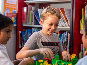 Children playing with LEGO in a library