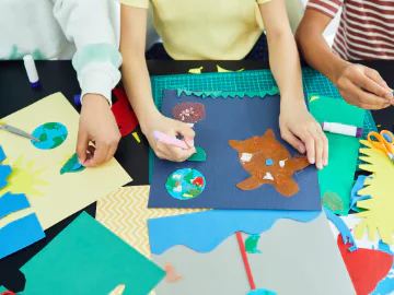 Children crafting with coloured paper