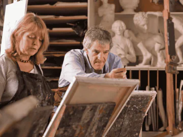 Artists painting on canvas in an art studio