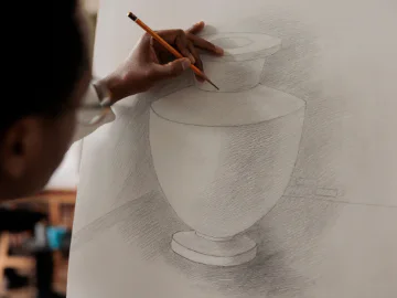 An artist drawing a vase