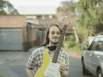 Sam Banks holding a guitar