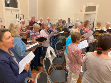 A group of singers in the Old Midland Courthouse