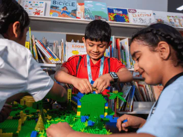 Young people building with LEGO in a library