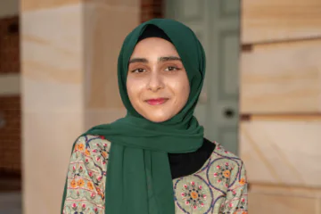 Zahina posing in front of a building