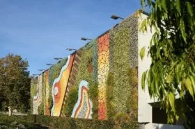 A large artwork on a wall featuring a vertical garden