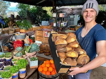 A man hold freshly baked bread at a produce store in the Swan Valley