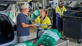 People sorting containers at a recycling centre