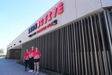 3 swan active staff members standing outside the front of the new swan active midland building