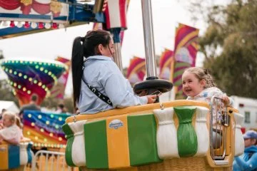 A mother and child enjoying a ride at the Avon Descent Festival 2025