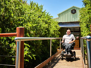 A man uses a wheelchair on a ramp