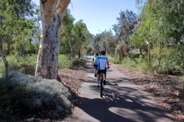 People riding in a bush park