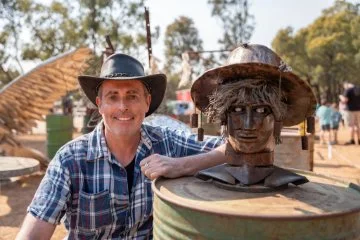 Leigh Shersby with his artwork 'Shoo Fly shoo' at the rustic Farm Art Awards 2024