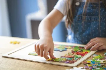 Young girl playing with puzzles.