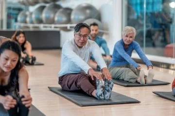 Seniors doing some mild yoga indoors
