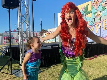 A mermaid talking with a child