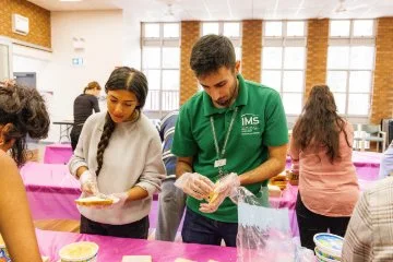People making sandwiches in a hall