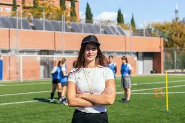 Confident female soccer coach supervising training session