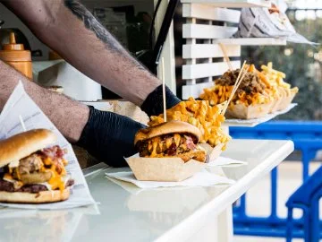 Loaded fries and burgers being served from a food truck