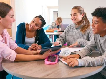 Kids doing homework around a table
