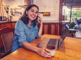 A woman working at her kitchen desk