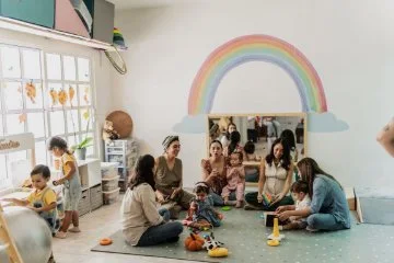 Mothers talking in a support group with their kids