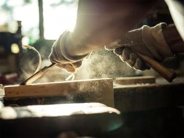 A person using a chisel to work wood