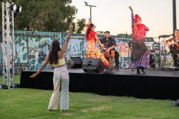 Person enjoying cultural performance at Fridays at Locale