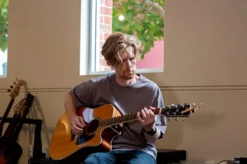 man playing acoustic guitar