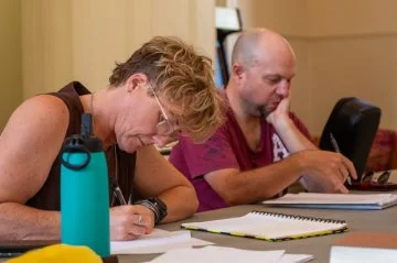 woman taking notes at a desk