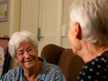 Smiling eldery lady sitting in a chair