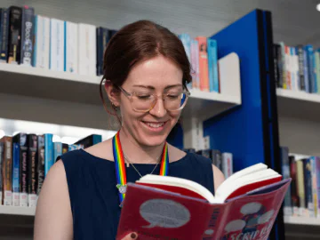 A person reading a book in a library