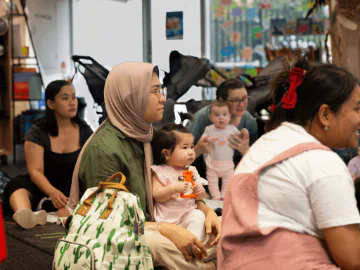 Children and parents at a storytime session in a library