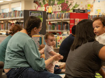 Children and parents at a storytime session in a library