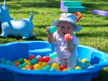 A child playing in a sensory tray