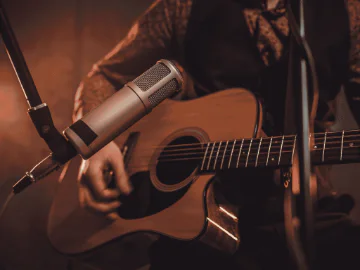 Musician playing guitar and a microphone