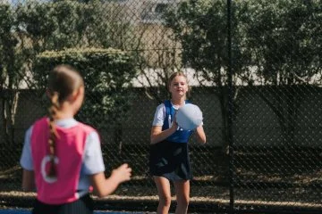 Two girls playing netball