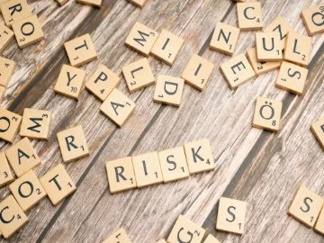 scrabble pieces spelling out 'risk'