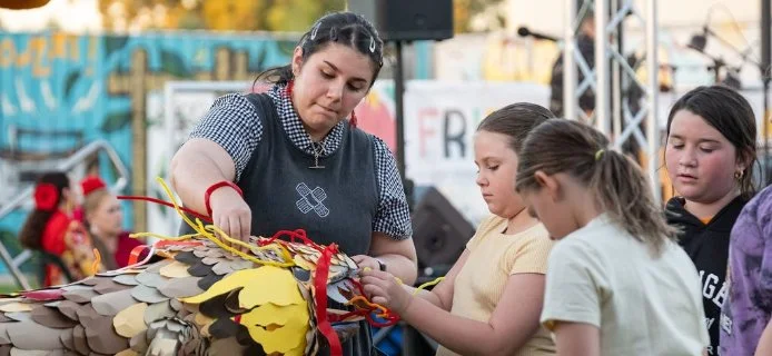 Children and an adult preparing decorations