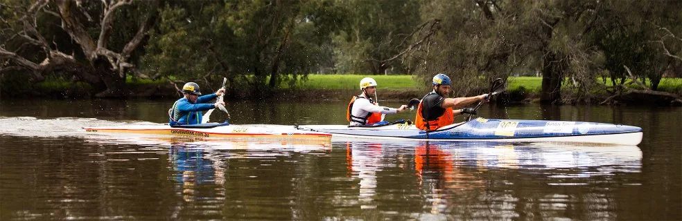 Three kayakers competing in the Avon Descent