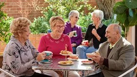 Seniors sitting around a table chatting