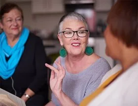 People talking at a Book Club gathering