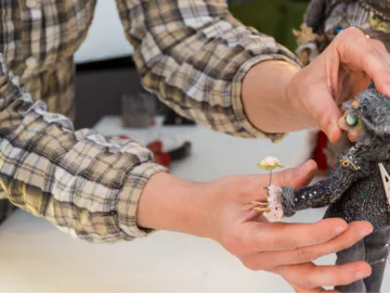 Hands holding a crafted figure
